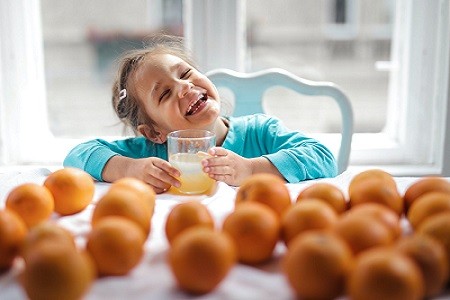 Child drinking orange juice