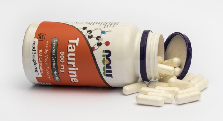 A taurine supplement spills from its bottle.