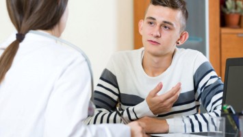 Jugendlicher im Gespräch mit Ärztin