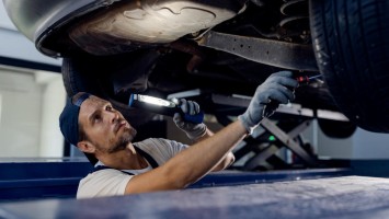 Mechanic inspects car