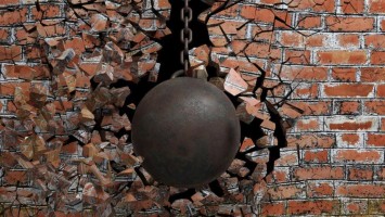 Mauer wird von Abrissbirne zerstört