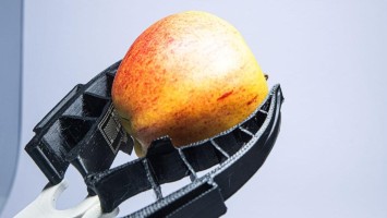 Robotic hand holding an apple 