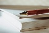 Image of book with pen