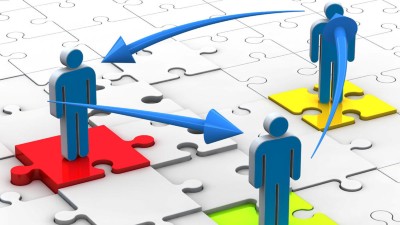 Figuren stehen auf Puzzleteilen