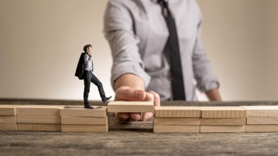 Kleiner Geschäftsmann läuft über eine Brücke, die der große Geschäftsmann hält