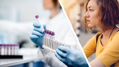 Behandschuhte Hand hält Laborröhrchen