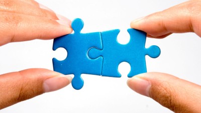 Two jigsaw pieces being put together