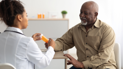 Doctor showing patient a pill bottle