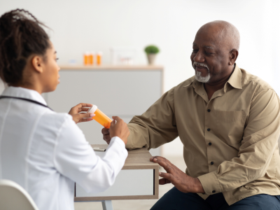 Doctor showing patient a pill bottle
