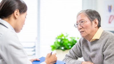 Elderly man talking to doctor