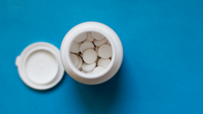 Top view of a bottle of white pills