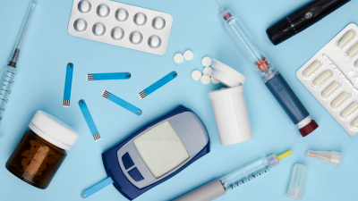 Photograph of a glucometer and diabetes medication