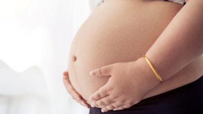 Pregnant woman holding her stomach