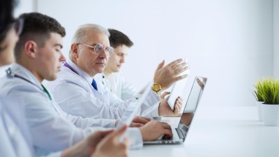 Medical team sitting and discussing at table 
