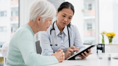 Doctor and patient looking at digital tablet