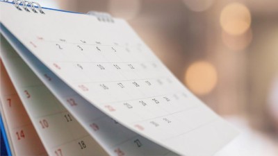 Close-up of desk calendar with pages flipping