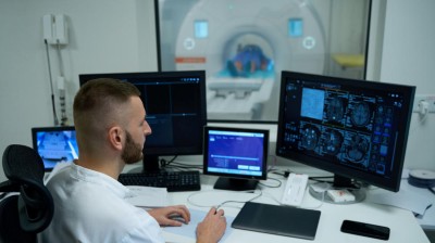 Technician performing MRI brain scan
