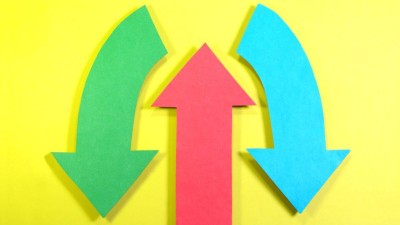 Image is a red arrow pointing upwards on a yellow background with a green and blue arrow on either side pointing downwards to illustrate the concept of decision-making
