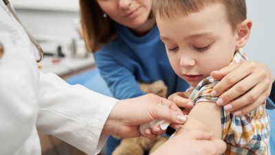 Junge bekommt Pflaster nach Impfung