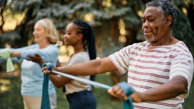 Senior man using a resistance band in an exercise class