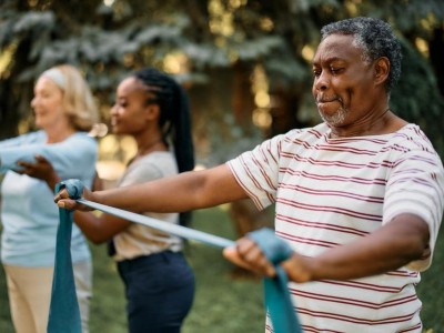Senior man using a resistance band in an exercise class