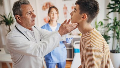 Arzt untersucht Teenager an den Lymphknoten