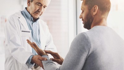 Arzt untersucht Hand