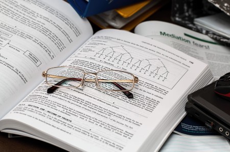 A reference book with glasses on it