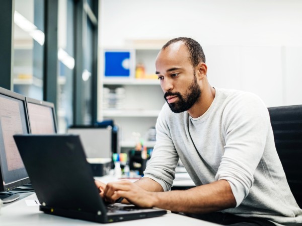 A scientist looks at his laptop