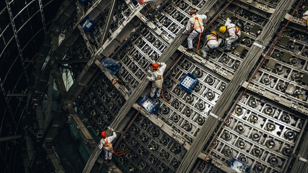 Workers at the Jiangmen Underground Neutrino Observatory.