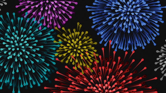 Colourful exploding fireworks, made up of on individual single cells, on a black background 