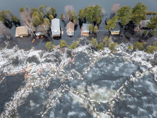 Huge chunks of ice propelled by wind and flood waters threatens cottages on Grand Lake, New Brunswick, Canada