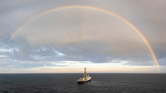 Picture of the drilling ship Joides Resolution, operated by the International Ocean Discovery Program (IODP), sailing beneath a rainbow on Expedition 403 to the Fram Strait.