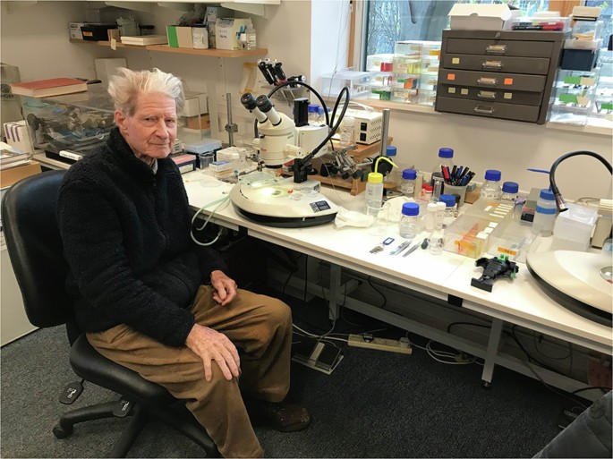 Fig. 2: John at his microscope in his office, where he performed nuclear transfer.