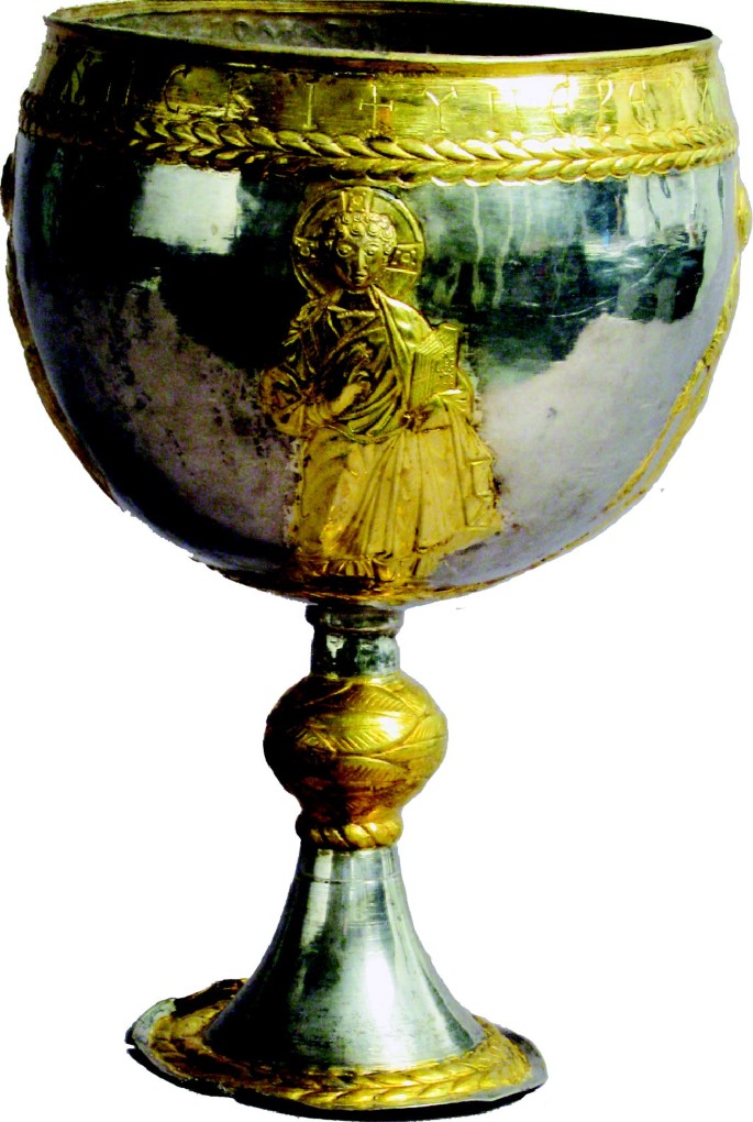 A photo of the chalice with an illustration of Jesus. He holds a large book.