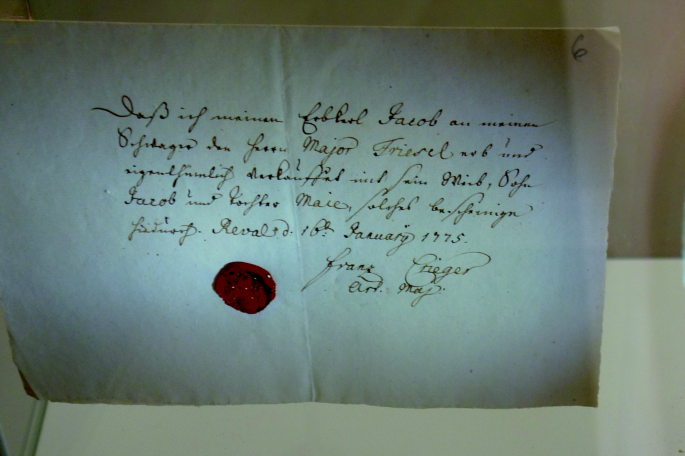 A handwritten text on a piece of paper with a signature and seal.
