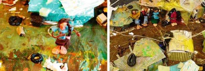 Two photographs of a model, with clay and peg characters standing on dirty pavements, by the side of houses made from recycled scrap materials such as carboard, netted cloth, and strings.