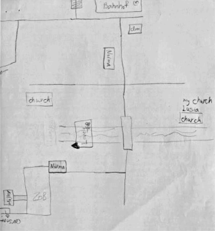 A photograph of a sketch map with accurate spatial information of the town center. There are roads, churches and so on.