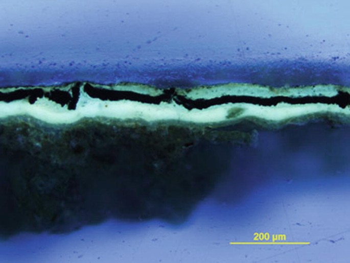 A photomicrograph of 200 microns of white ground depicts whitish fluorescence under U V radiation.