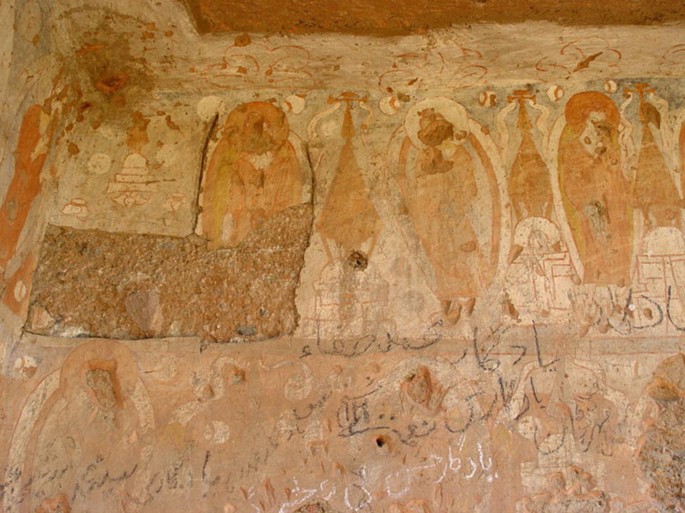 A photograph of the north wall of Cave C depicts a wall painting with a portion of the painting missing.