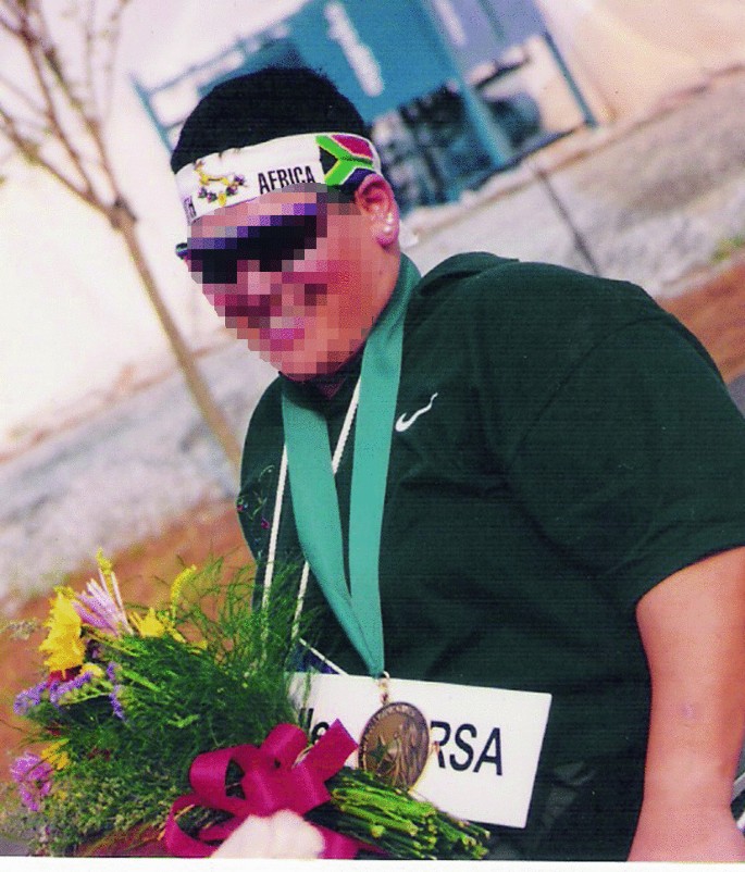 A photograph of Rosabelle wearing a medal and holding a bouquet.