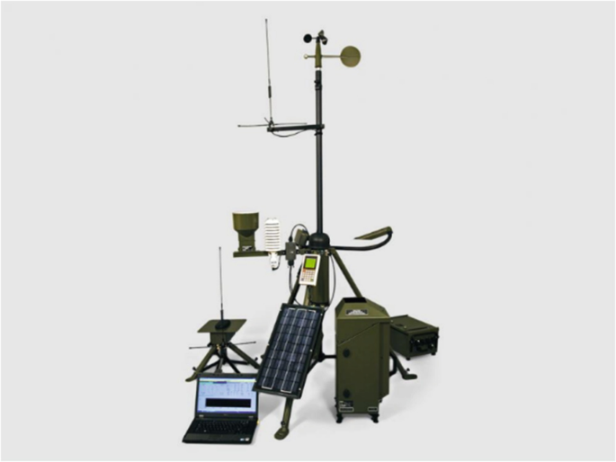 A photograph of a portable real-life weather station set up. It includes a tripod and a laptop.