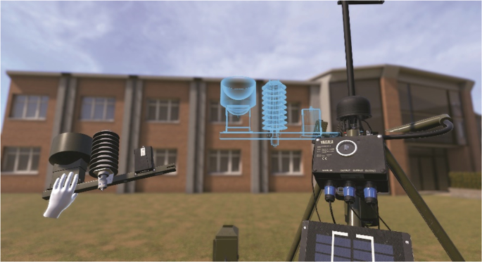 A photograph of a virtual environment presents a building in the background and a tripod in front. A virtual hand holds a part of the equipment, and a hologram of the same is created.