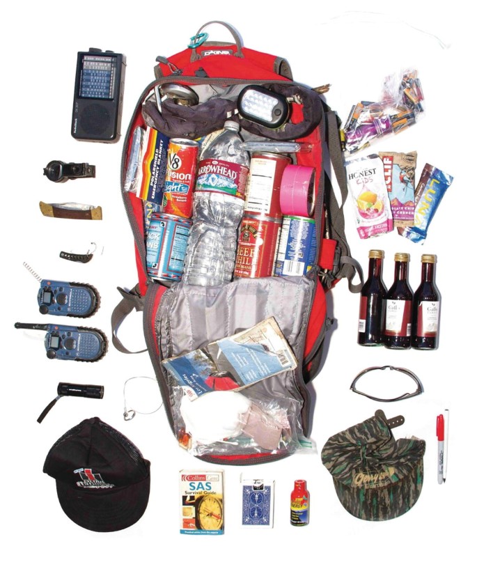 A photograph represents a bag with walkie-talkies, hats, water bottles, pens, and so on.