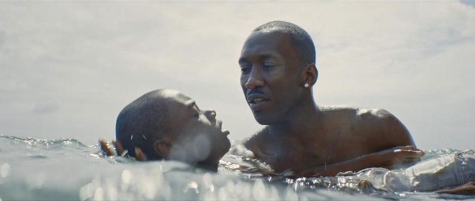 A screen capture from the movie, Moonlight. Mahershala Ali's Juan holds Chiron and teaches him to swim at the beach.