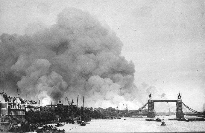 A photograph of smoke rising from fires in the London docks.