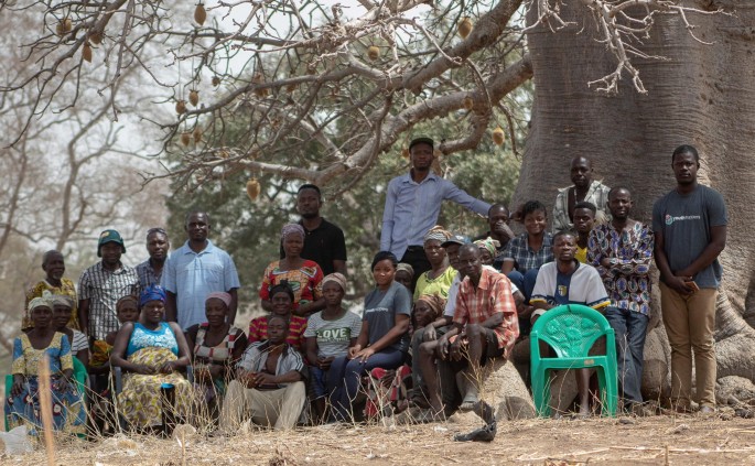 A group photograph of people under a tree.