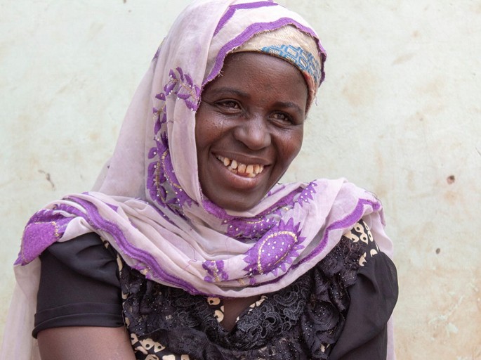 A photograph of a woman with a wide smile on her face.