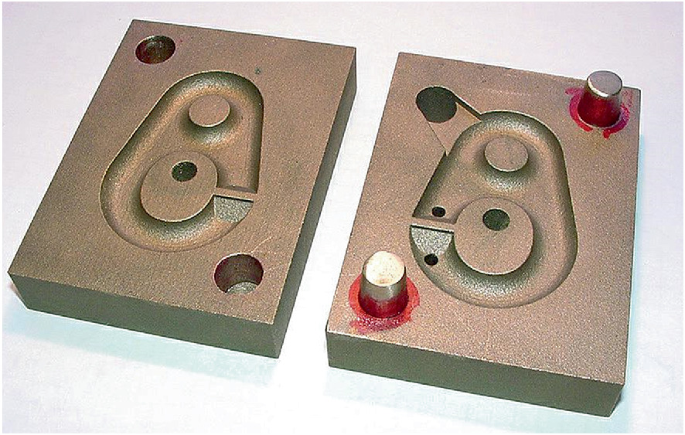 The photo of an A M hard mould has a track like closed path with an opening and closing end that are to be connected together.