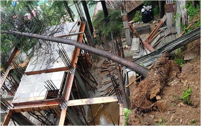 A photograph depicts the over-excavation of debris in Dharamshala, bars and bricks can be seen. A large tree fell on the roof of a building.